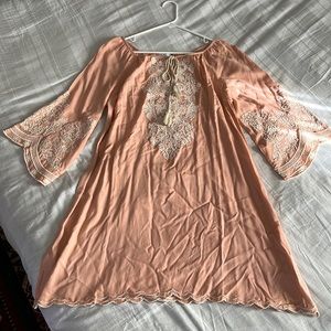 Chic connection dress with embroidery. Peach/light pink with tan embroidery.